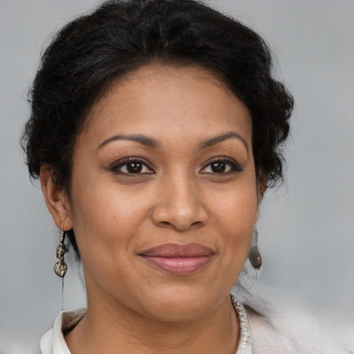 Joyful black adult female with medium  brown hair and brown eyes