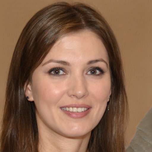 Joyful white young-adult female with long  brown hair and brown eyes