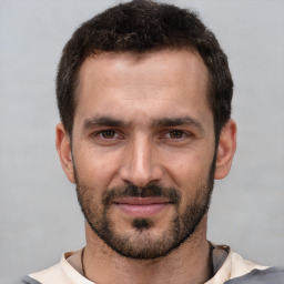 Joyful white young-adult male with short  black hair and brown eyes