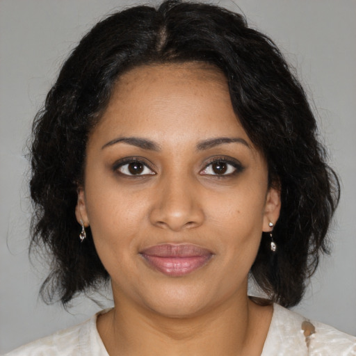 Joyful black young-adult female with medium  brown hair and brown eyes