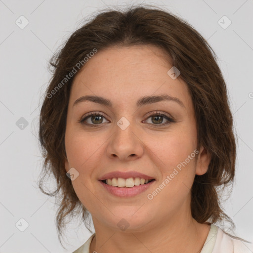 Joyful white young-adult female with medium  brown hair and green eyes