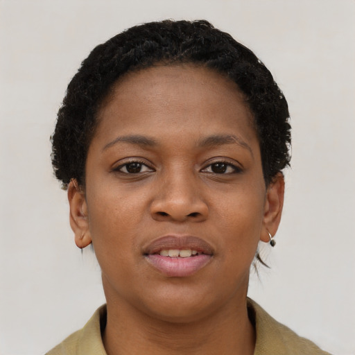 Joyful black young-adult female with short  brown hair and brown eyes