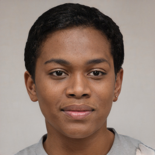 Joyful black young-adult female with short  black hair and brown eyes