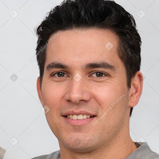 Joyful white young-adult male with short  black hair and brown eyes