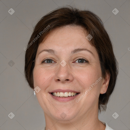 Joyful white adult female with medium  brown hair and grey eyes