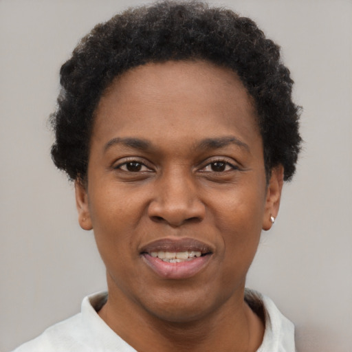 Joyful black young-adult female with short  black hair and brown eyes