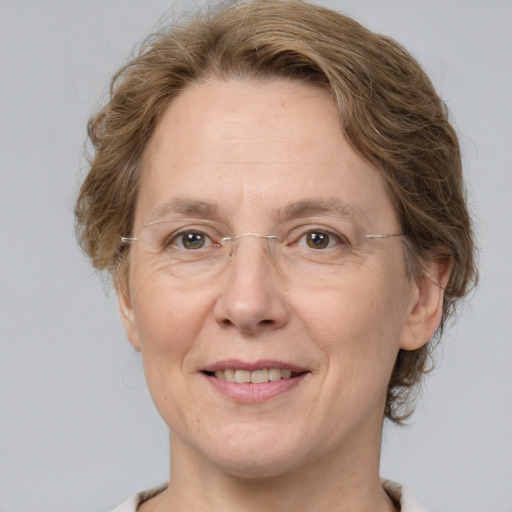 Joyful white adult female with medium  brown hair and grey eyes