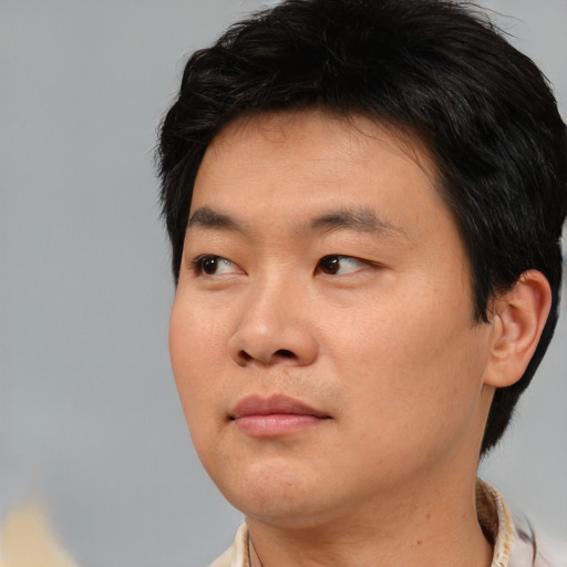 Neutral asian young-adult male with short  brown hair and brown eyes