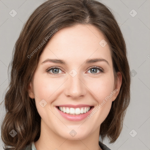 Joyful white young-adult female with medium  brown hair and green eyes