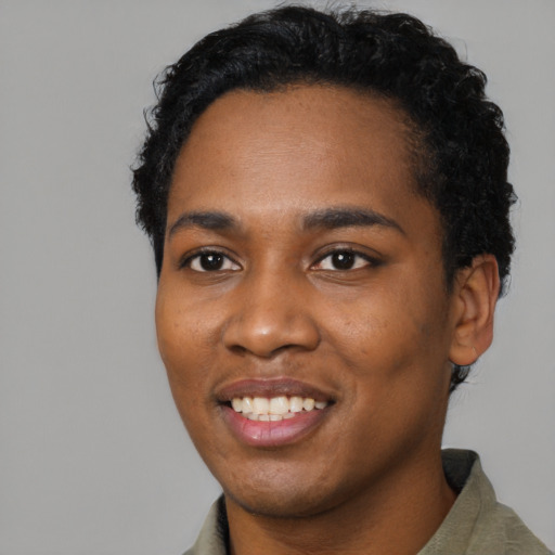 Joyful black young-adult male with short  black hair and brown eyes