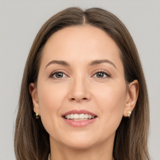 Joyful white adult female with long  brown hair and brown eyes