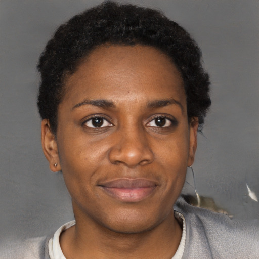 Joyful black young-adult female with short  black hair and brown eyes