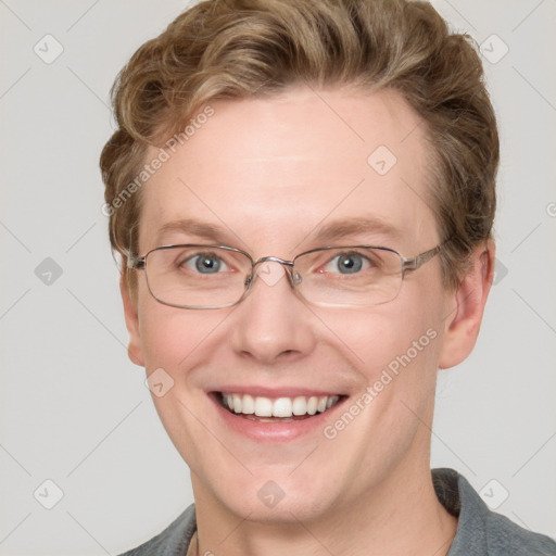 Joyful white adult male with short  brown hair and blue eyes