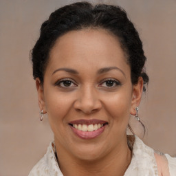 Joyful black adult female with medium  brown hair and brown eyes