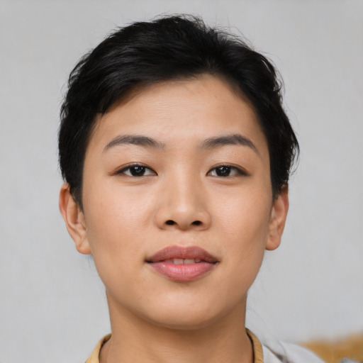 Joyful asian young-adult female with short  black hair and brown eyes