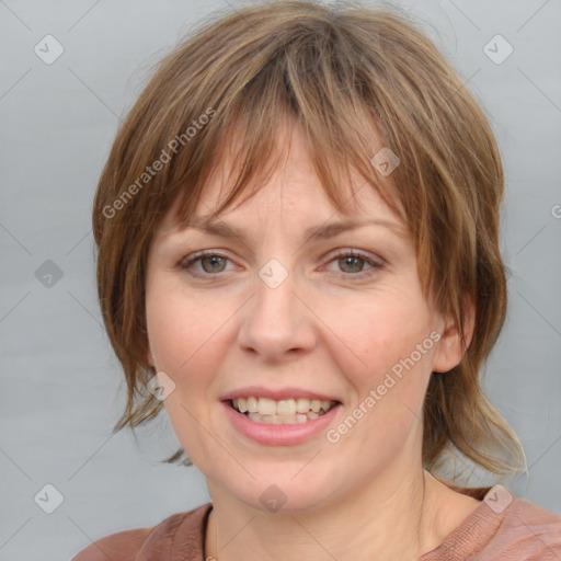 Joyful white young-adult female with medium  brown hair and blue eyes