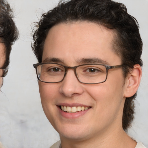 Joyful white young-adult male with medium  brown hair and brown eyes