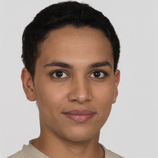 Joyful latino young-adult male with short  brown hair and brown eyes