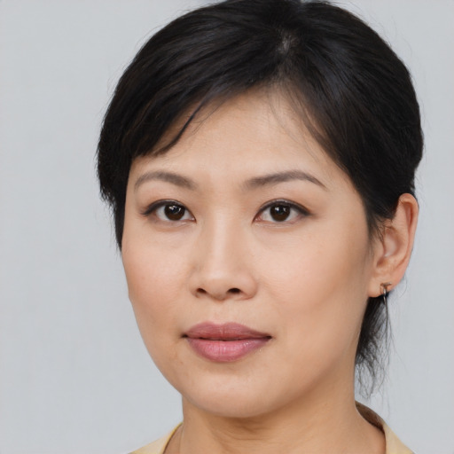 Joyful asian young-adult female with medium  brown hair and brown eyes