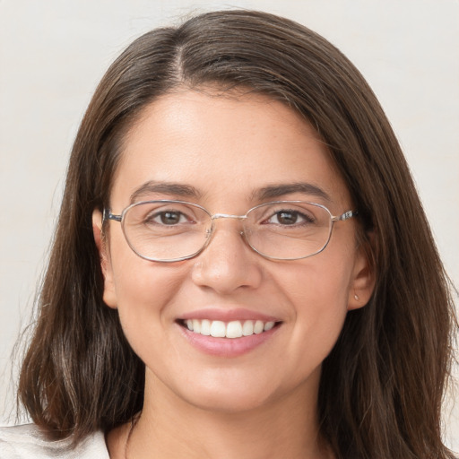 Joyful white young-adult female with long  brown hair and grey eyes