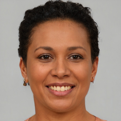 Joyful black adult female with short  brown hair and brown eyes