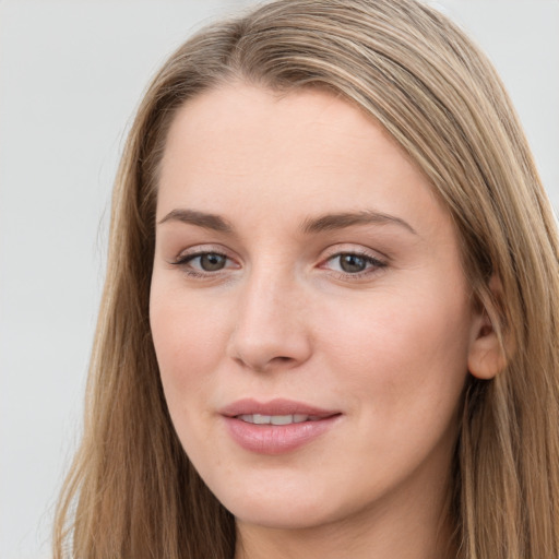 Joyful white young-adult female with long  brown hair and blue eyes