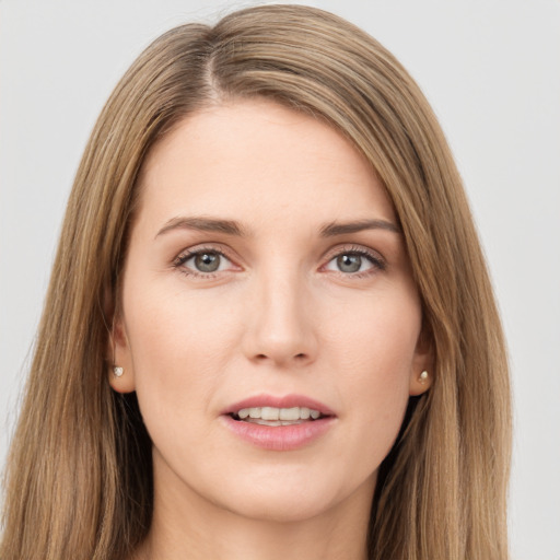 Joyful white young-adult female with long  brown hair and grey eyes