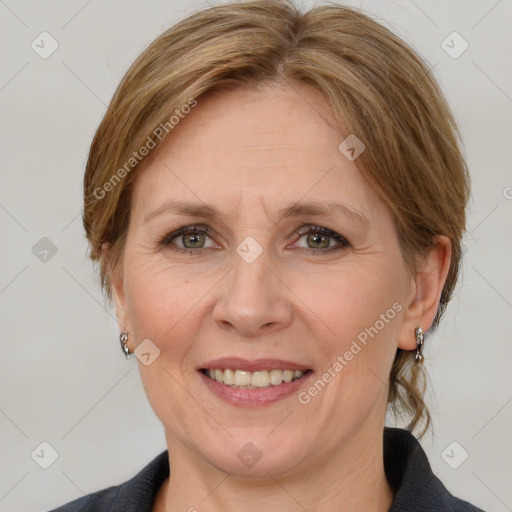 Joyful white adult female with medium  brown hair and grey eyes