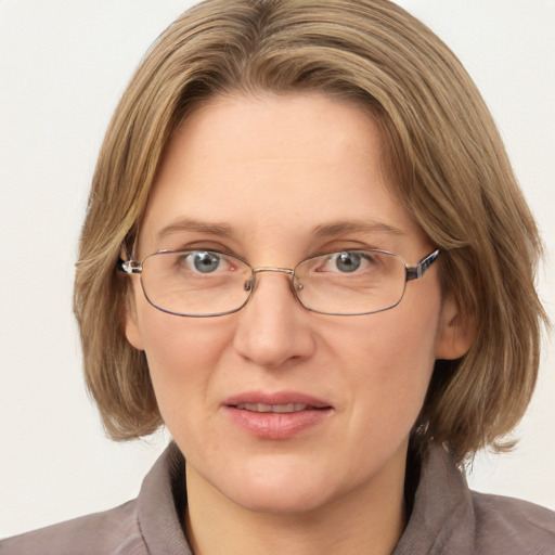 Joyful white adult female with medium  brown hair and blue eyes