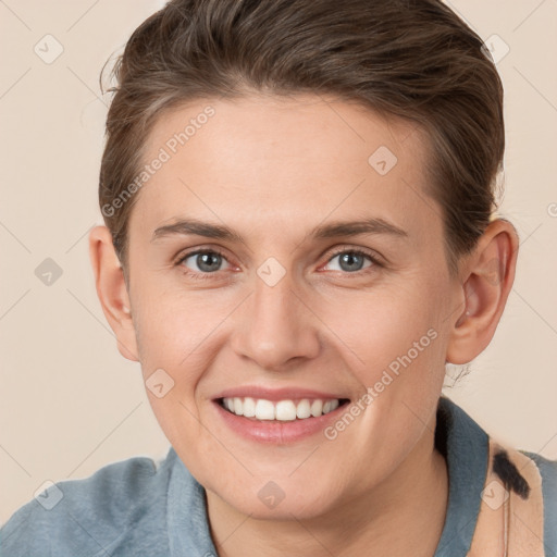 Joyful white young-adult female with short  brown hair and grey eyes