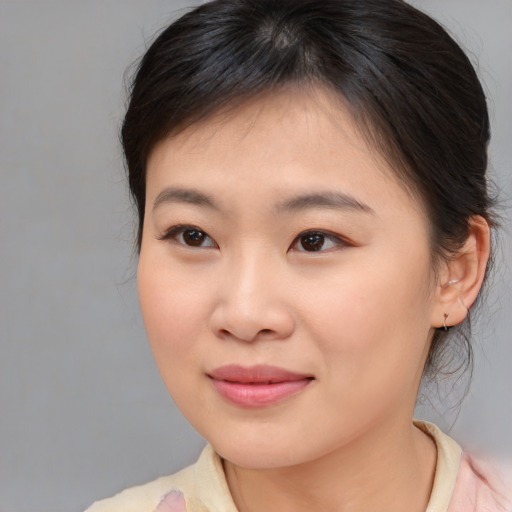 Joyful asian young-adult female with medium  brown hair and brown eyes