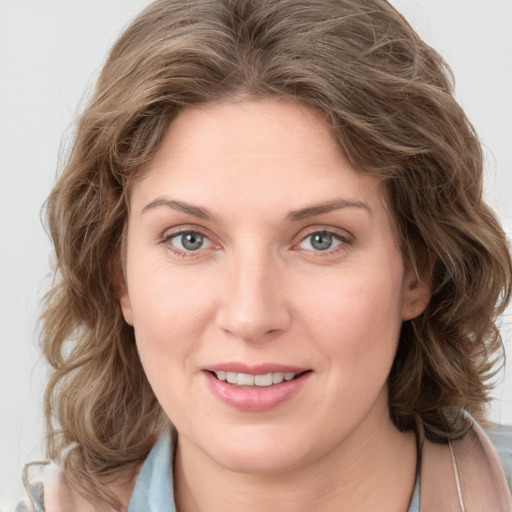 Joyful white young-adult female with medium  brown hair and green eyes