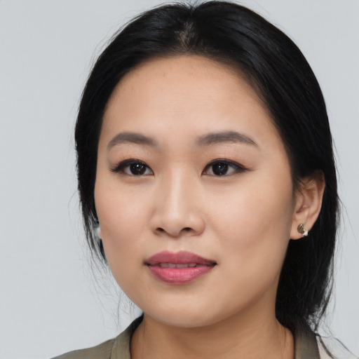Joyful asian young-adult female with medium  black hair and brown eyes