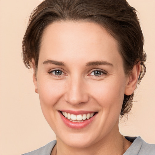 Joyful white young-adult female with medium  brown hair and brown eyes