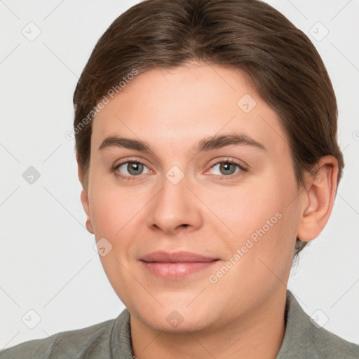 Joyful white young-adult female with short  brown hair and grey eyes