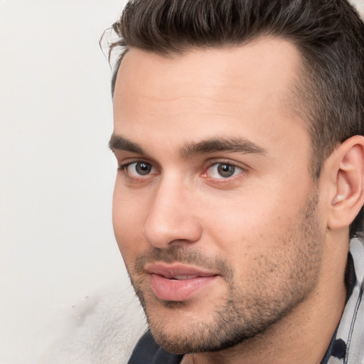 Joyful white young-adult male with short  brown hair and brown eyes