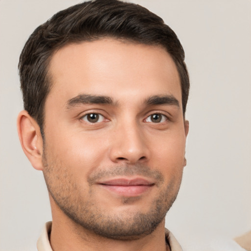 Joyful white young-adult male with short  brown hair and brown eyes