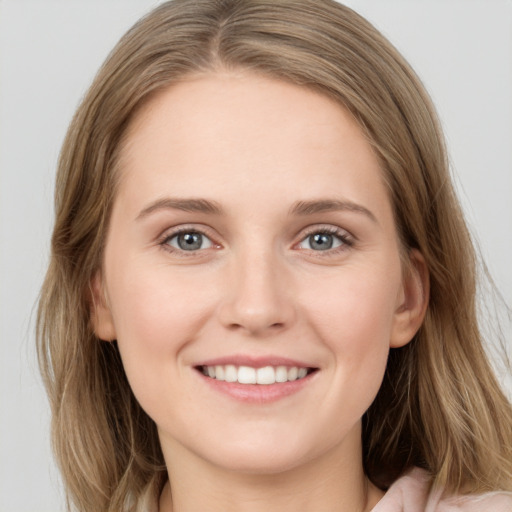 Joyful white young-adult female with long  brown hair and grey eyes