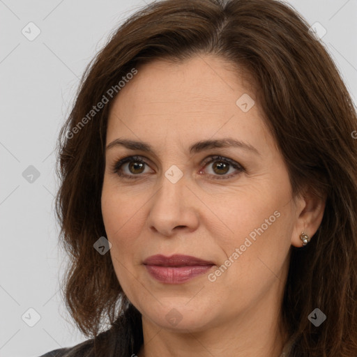 Joyful white adult female with long  brown hair and brown eyes