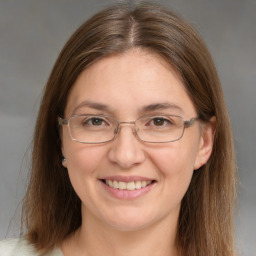 Joyful white adult female with medium  brown hair and brown eyes