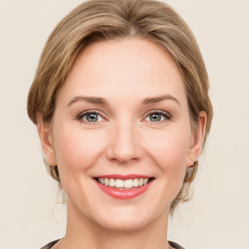 Joyful white young-adult female with medium  brown hair and green eyes