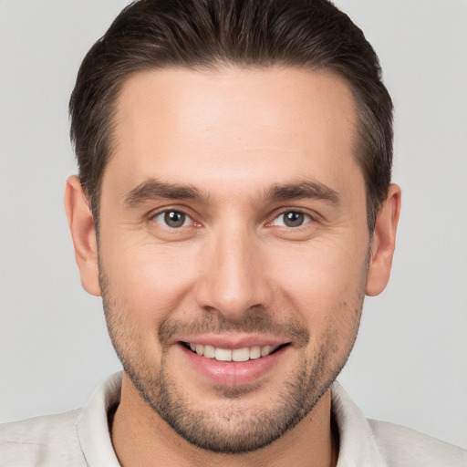 Joyful white young-adult male with short  brown hair and brown eyes