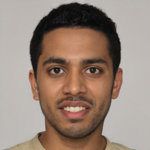 Joyful latino young-adult male with short  black hair and brown eyes