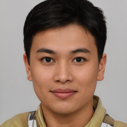 Joyful asian young-adult male with short  brown hair and brown eyes