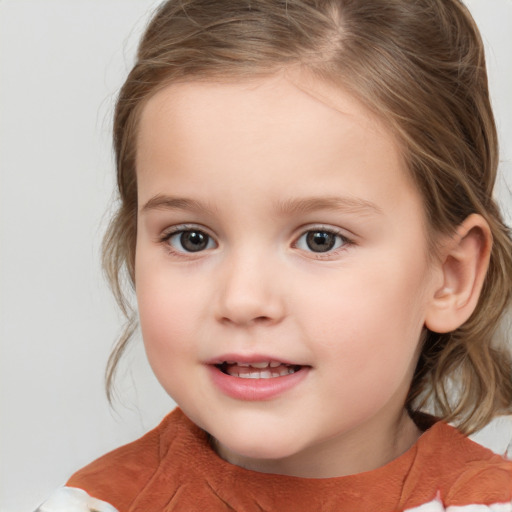 Joyful white child female with medium  brown hair and grey eyes