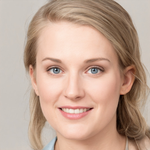 Joyful white young-adult female with medium  brown hair and blue eyes