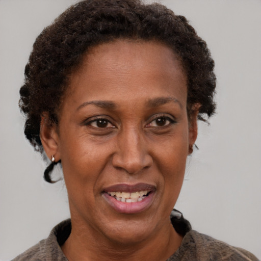 Joyful black adult female with short  brown hair and brown eyes
