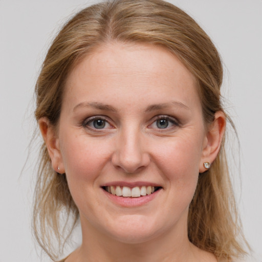 Joyful white young-adult female with medium  brown hair and blue eyes