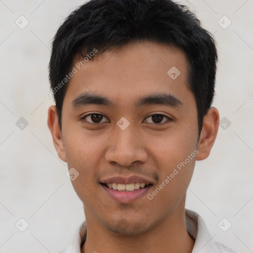 Joyful asian young-adult male with short  brown hair and brown eyes