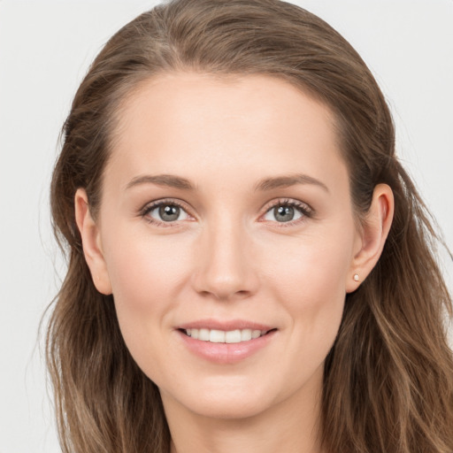 Joyful white young-adult female with long  brown hair and grey eyes